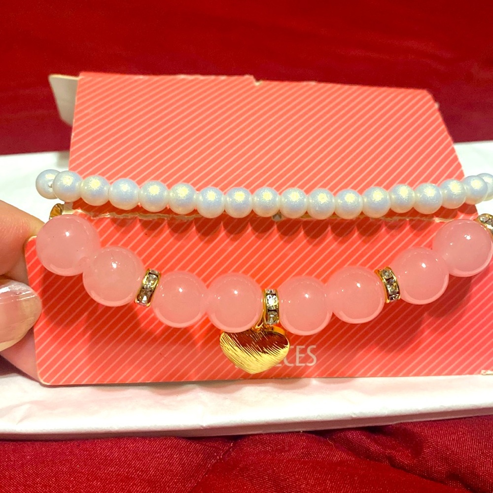 Pink with a gold heart and white bracelet